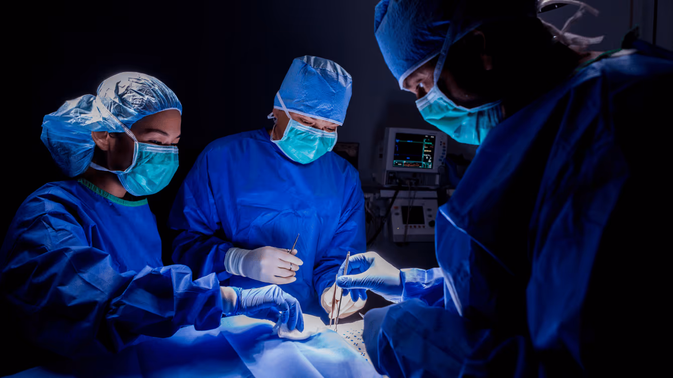 Surgical team operating under EPMD operating room lighting