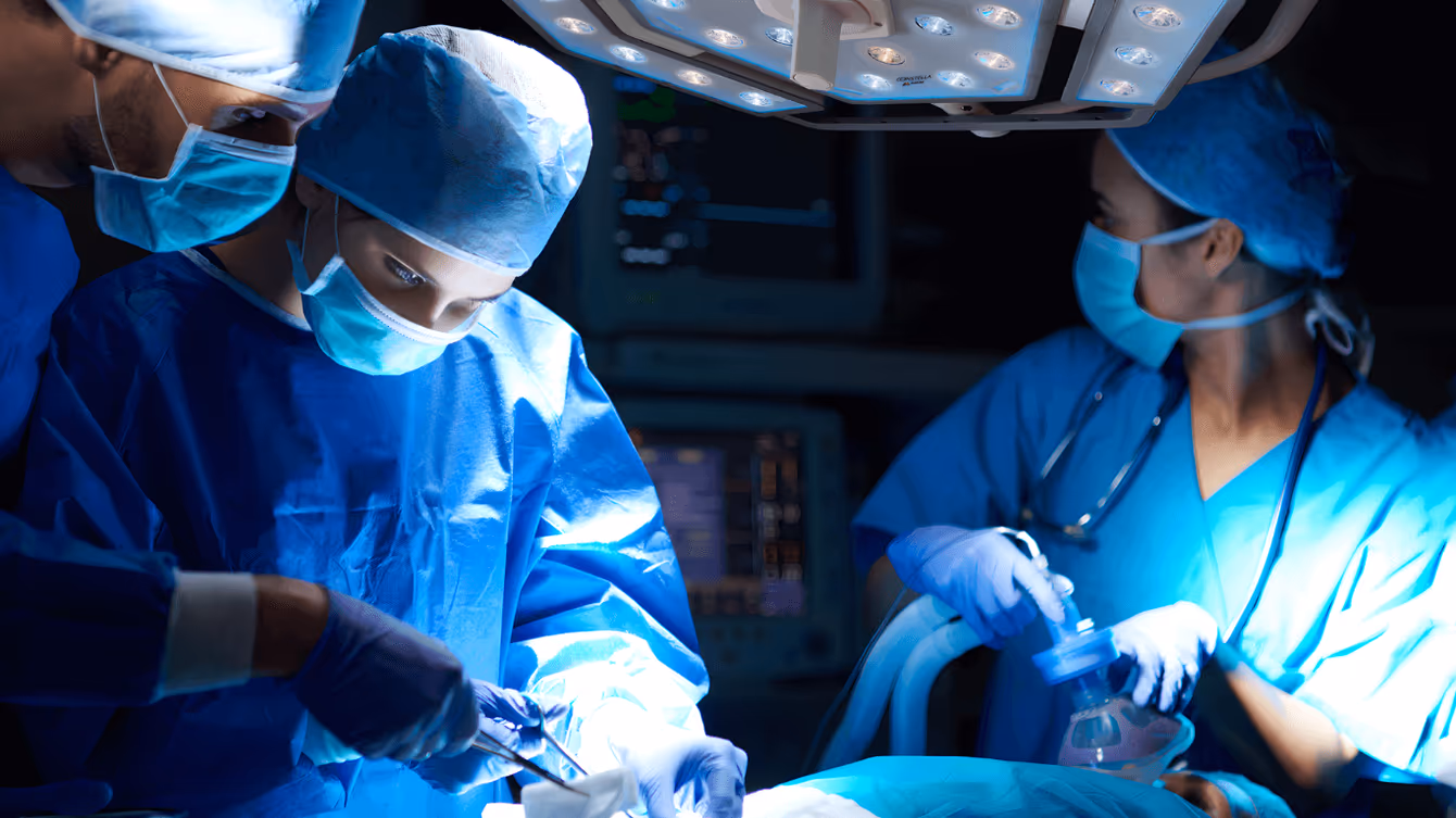 Surgical team operating under EPMD operating room lighting